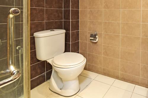 a bathroom with a toilet and a shower at Collection O Melaka Near Dataran Pahlawan Formerly Ideals Hotel in Melaka