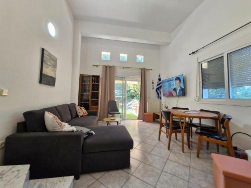a living room with a couch and a table at Relax Dream Villa-House, Apartement, Studio in Kallithea Halkidikis