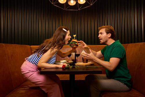 a man and a woman sitting at a table in a restaurant at HUP in Mierlo