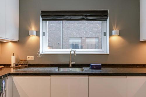 a kitchen with a sink and a window at Huswell - Lovely retreat for 2 in Antwerp in Antwerp