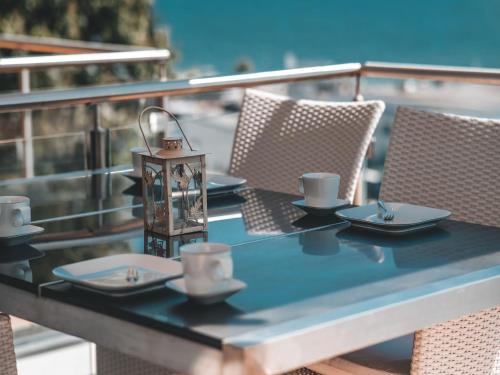 a table with cups and saucers on a balcony at Villa Friede-Marie, Ostseeweitblick in Sassnitz