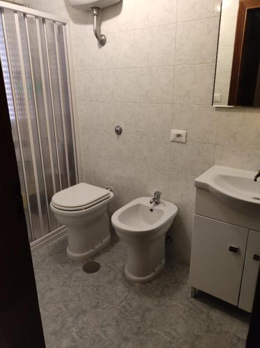a bathroom with a toilet and a sink at Sognando Ostuni in Ostuni