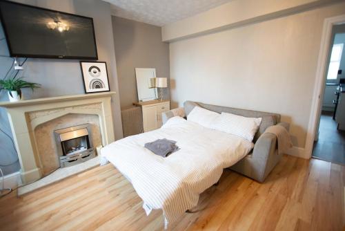 a living room with a bed and a fireplace at Saint Nico in Carlisle