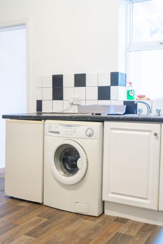 a washer and dryer under a counter in a kitchen at Saint Nico in Carlisle