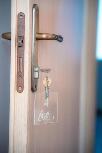 a door latch with a key on it at Leo Rooms & Sea in Torre San Giovanni Ugento