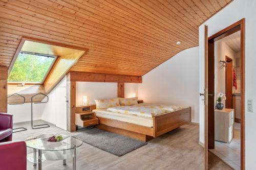 a bedroom with a bed and a wooden ceiling at Gästehaus Gaby in Bad Bellingen