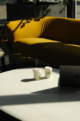 two cups on a table in front of a couch at Holiday Inn - Tbilisi by IHG in Tbilisi City