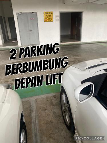 a white sports car parked in a parking lot at Sutra Impian Seaview Sutra Villa 2 in Kuantan