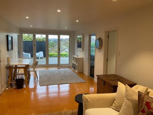 a living room with a couch and a table at Central City Haven in Auckland