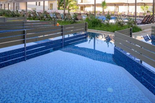 a pool at a resort with blue water at Zeus Hotels Ydoria Resort in Adelianos Kampos