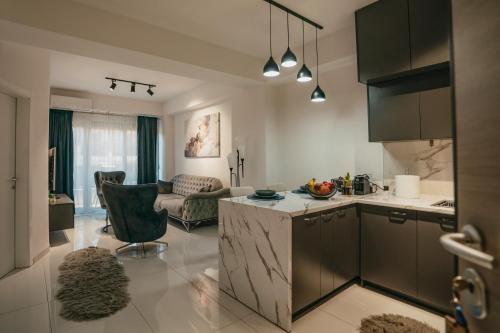 a kitchen and living room with a table and a counter at Damast Lux apartments 20 in Ohrid