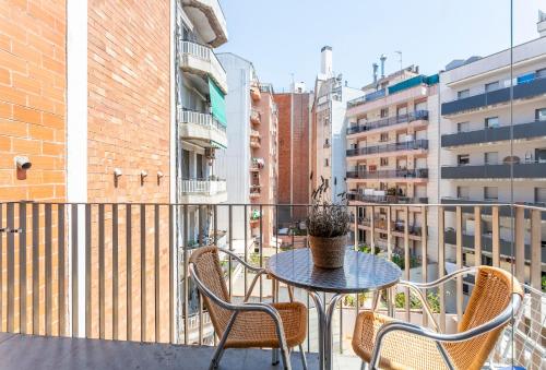 a patio with a table and chairs on a balcony at My Space Emirates - Fully equipped apartments near the Beach with shared pool in Barcelona