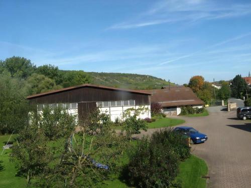 a house with a car parked in front of it at Ferienwohnung Mit Terrasse Und Parkplatz in Igersheim