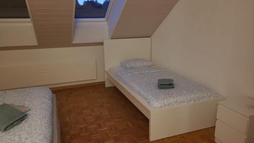 a small room with two beds and a window at VK - VB - Zürich Airport - Homestay - Villa Bänikon in Kloten