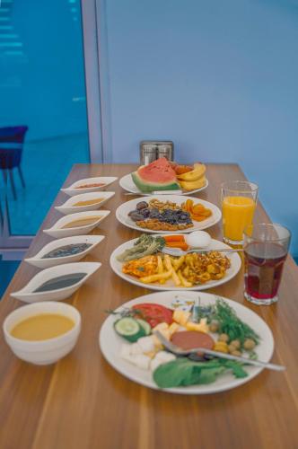 a table with many plates of food on it at Danzha Hotel 2 in Erbil