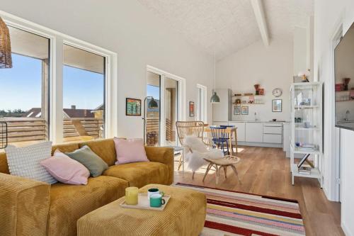 a living room with a couch and a table at Feriehus 1135 in Ringkøbing
