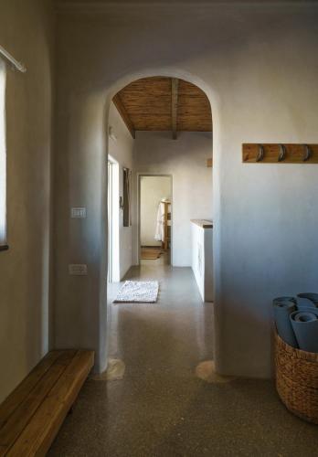 a hallway of a house with a table and a bench at Nof Zuqim in Zuqim