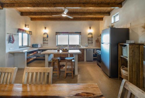 a kitchen with a table and a refrigerator at Nof Zuqim in Zuqim