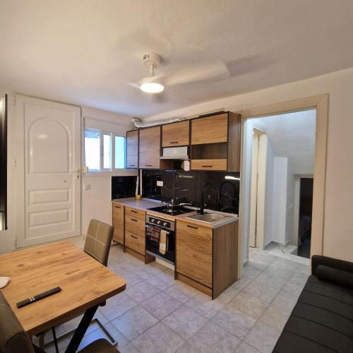 a kitchen with wooden cabinets and a wooden table at Relax Dream Villa-House, Apartement, Studio in Kallithea Halkidikis