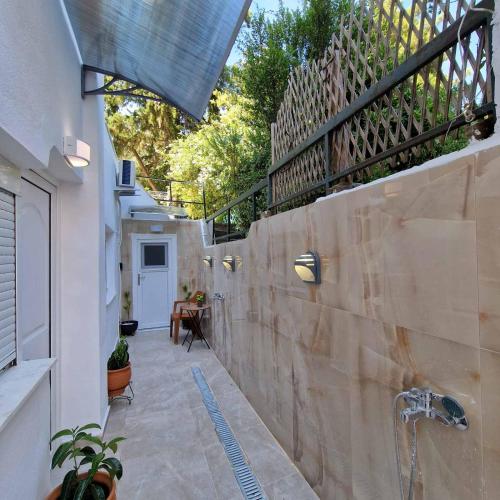 a bathroom with a stone wall with a faucet at Relax Dream Villa-House, Apartement, Studio in Kallithea Halkidikis