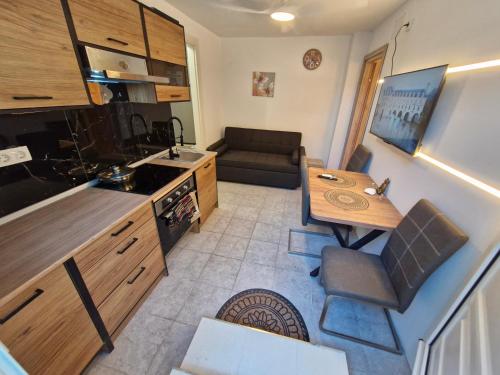 a kitchen and living room with a table and a couch at Relax Dream Villa-House, Apartement, Studio in Kallithea Halkidikis