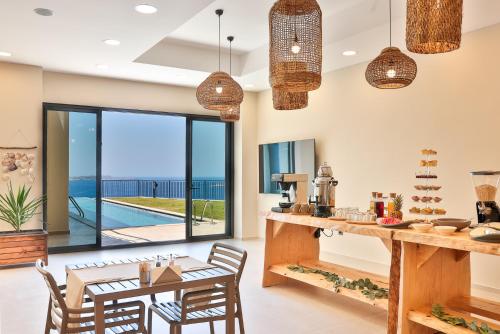 a dining room with a table and chairs and a view of the ocean at Lyxos Hotel in Kas