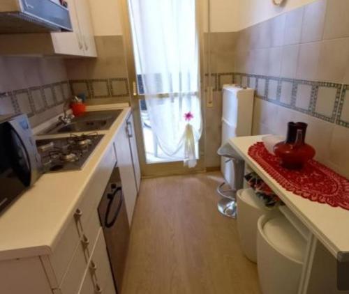 a small kitchen with a sink and a refrigerator at Casa Nilva Holiday in Sanremo in Sanremo