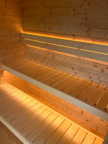a wooden inside of a sauna with lights on it at Caragh Lake House - Lakefront Escape and Sauna in Killorglin