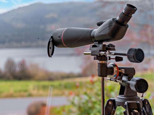 a camera on a tripod with a lake in the background at 3 Bed in Pitlochry CA207 in Struan