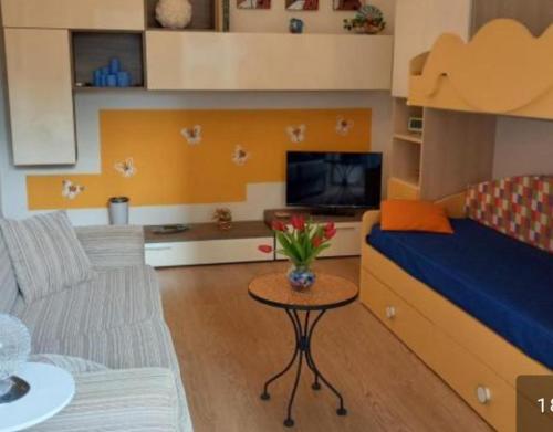 a small living room with a bed and a table at Casa Nilva Holiday in Sanremo in Sanremo