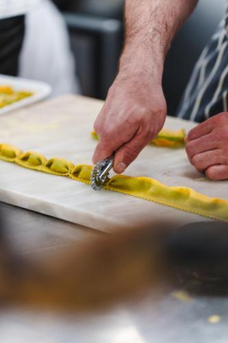a person using a tool to prepare a cake at Morston Hall in Holt