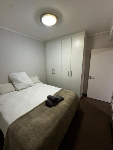 a bedroom with a large bed with a white bedvisor at Lakeside 2 Bedroom apartment in Tyger Valley