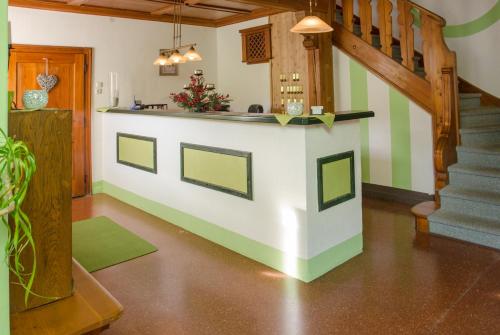 a kitchen with a island in the middle of a room at Hotel Garni Botenwirt in Spital am Pyhrn