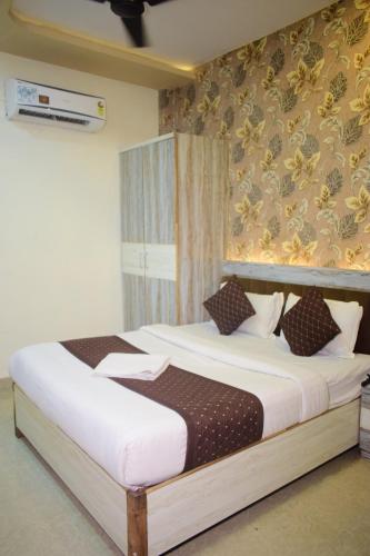 a bedroom with a bed in a room at Vinayak shree hotel in Indore