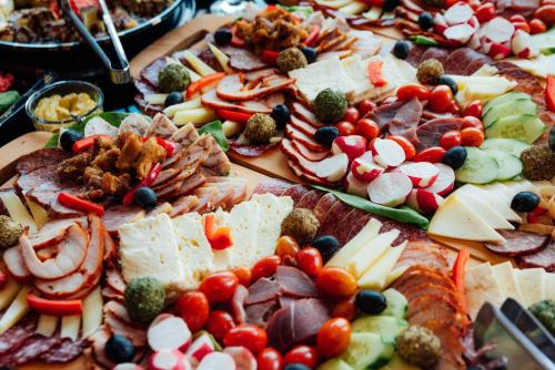 a table filled with lots of different types of food at Pensiunea Ursul Carcotas in Fundata