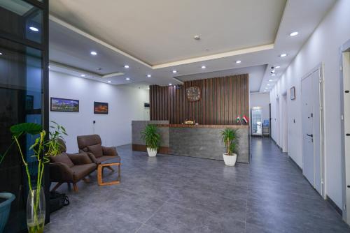 an office lobby with chairs and a reception desk at Danzha Motel Erbil in Erbil