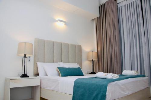 Ένα ή περισσότερα κρεβάτια σε δωμάτιο στο Hasara Oceanfront Apartments