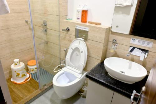 a bathroom with a toilet and a sink at Red Stone Villa - Shimla in Shimla