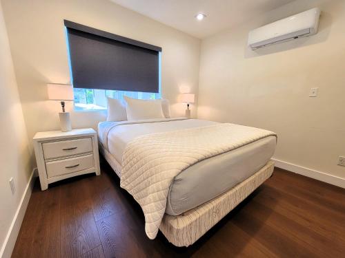 a bedroom with a large bed and a window at Newly built three bedroom close to Rodeo Drive Hollywood Downtown and Beaches Close to attractions in Los Angeles