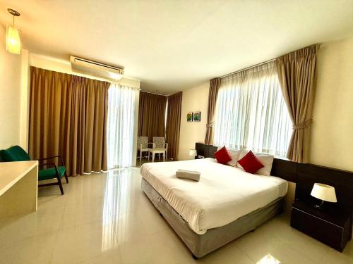 a hotel room with a large bed in a room at Apo Hotel in Krabi town