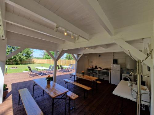 a kitchen and dining area of a house with wooden floors at Rõmeda kämping in Rõmeda