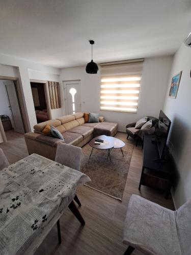 a living room with a couch and a table at Guest House Martinovic in Bečići