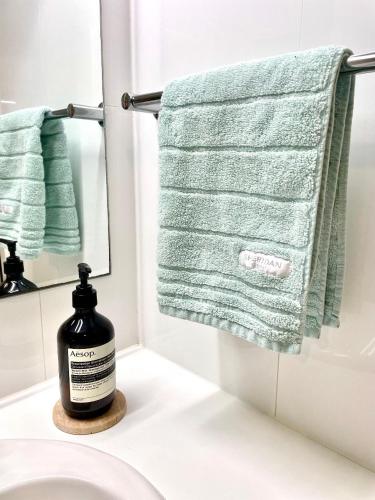 a bathroom with a bottle of soap on a sink at Edge17 Waterfront Apartment, plus Cottage with Garden View - Port Fairy in Port Fairy