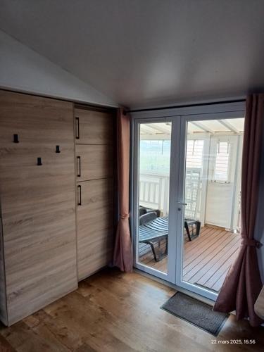 a room with a sliding glass door and a balcony at Camping siblu Valras-Plage in Valras-Plage
