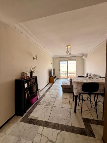 a living room with a table and a couch at Luxury Apartment Ocean View and Private Beach Ain Diab in Casablanca