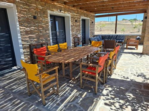 a wooden table and chairs on a patio at Keros Bay View in Kalliópi