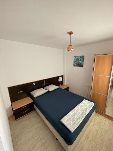 a bedroom with a large blue bed in a room at Medeea's Spanish Sunny Escape in Vinarós