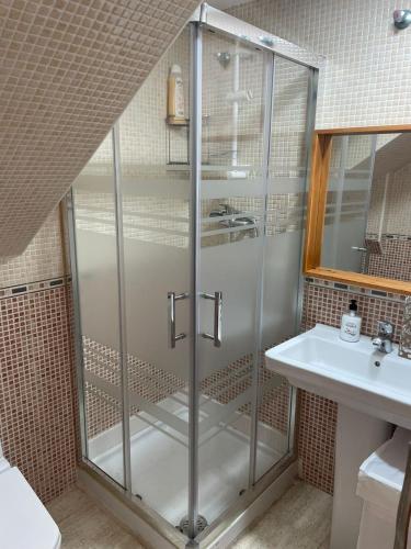 a shower stall in a bathroom with a sink at Medeea's Spanish Sunny Escape in Vinarós
