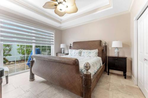 a bedroom with a bed and a ceiling fan at Villa La Esperanza-Holmes Beach 201 in Anna Maria Island