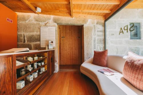 a living room with a couch and a wine cellar at Torel Saboaria in Porto